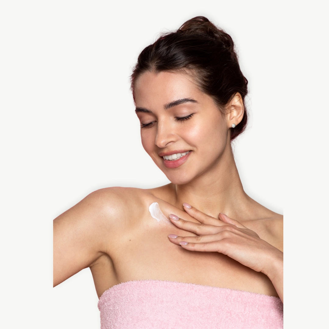 Woman applying body cream to support skin barrier and prevent body odor naturally
