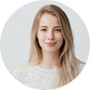 Smiling woman with clear skin, symbolizing customer confidence in Soaporize body care solutions