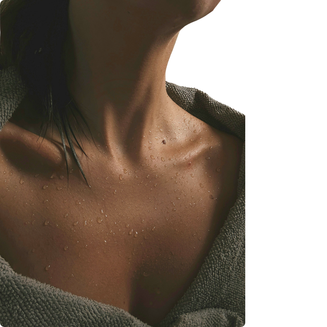 Close-up of freshly cleansed skin with water droplets on chest and neck – natural skincare ritual in progress